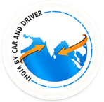 Circular badge logo featuring a blue globe with orange arrows circling it and the text 'DRIVEN BY CAR AND DRIVER' around the rim; branding emblem for Car and Driver.