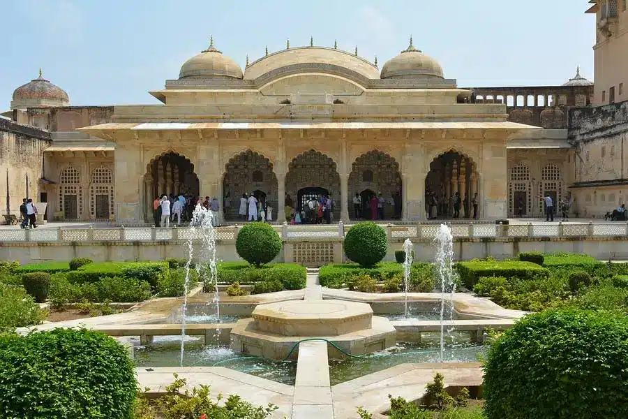Islamic-style pavilion with arches and a central fountain garden, and visitors exploring the courtyard.